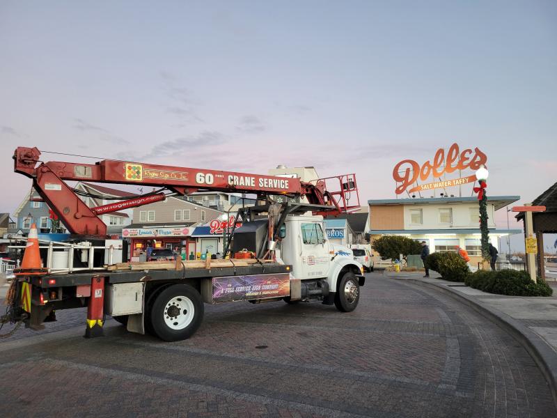 The crew from Milton’s Rogers Sign Co. has arrived to take down the iconic Dolle’s sign. CHRIS FLOOD PHOTO